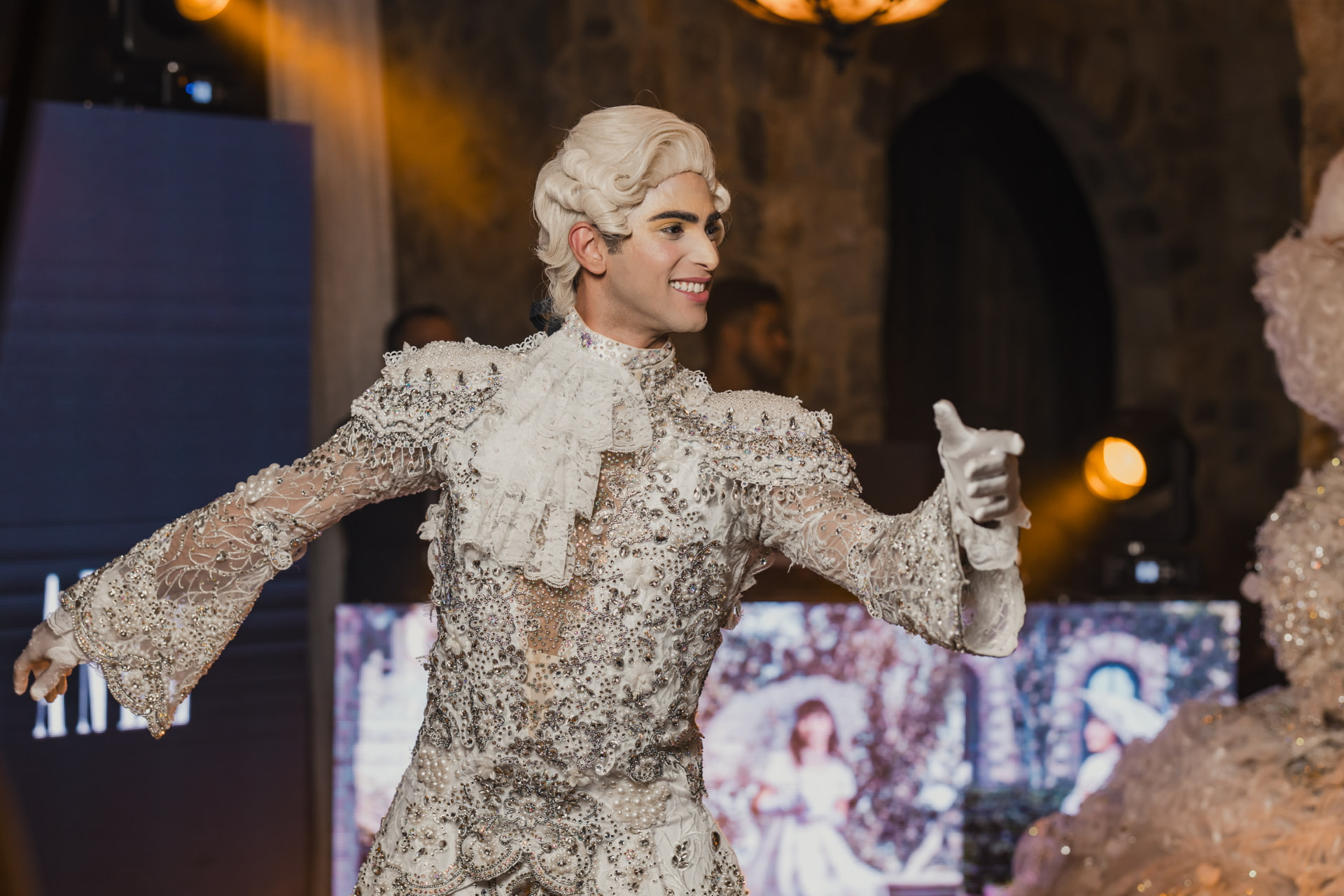 Baroque performer in an embellished white costume on stage