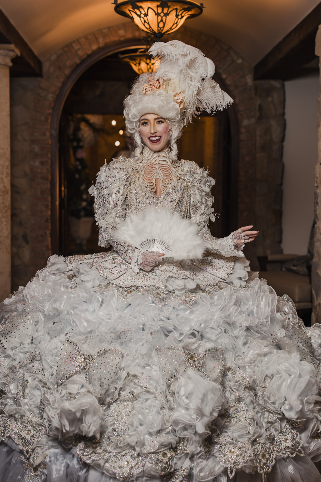 Baroque character in a white plumed wig and crystal gown